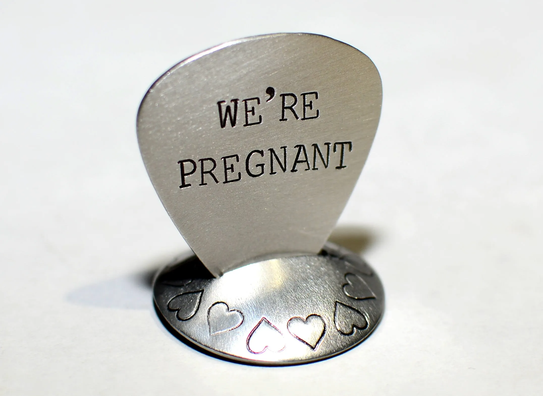 We’re Pregnant Guitar Pick for a Rocking Surprise in your choice of metals